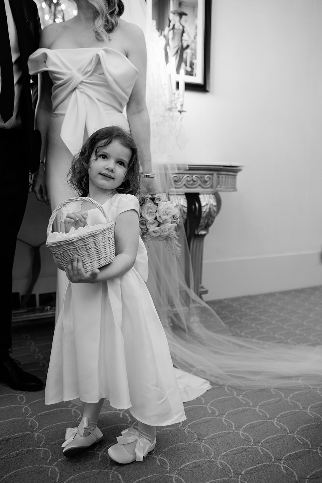 Flower girl holding a basket before an intimate wedding at Hôtel Plaza Athénée Paris